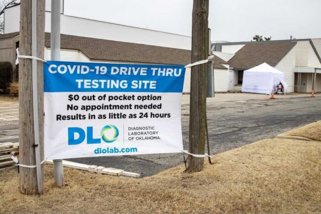 Sign says COVID-19 DRIVE THRU TESTING SITE. $0 out of pocket option. No appointment neeeded. Results in as little as 24 hours. Diagnostic Laboratory of Oklahoma.