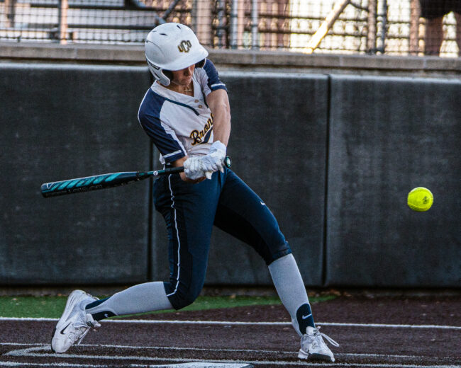UCO softball player swinging the bat (Hunter George/The Vista)