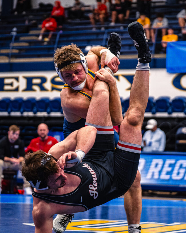 UCO's Branson Britten sweeps his opponent's leg, to take the match down to the mat. (Hunter George/ The Vista)
