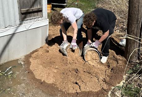 Students emptying dirt outside a flooded mobile home. Left: John Imbush/ Right: Alan Rodarmel (Hawkel Clemens/The Vista)