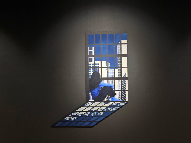 "Traces of Blue" by Lauren Tarter a woman sits on her balcony at night looking out into the city sky line. (Greyson Boutin/The Vista)