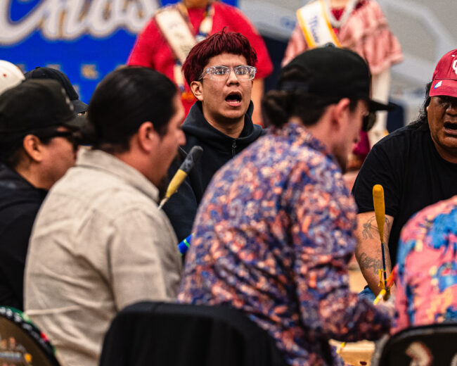 A young man is highlighted singing with the host drum (Hunter George/The Vista)
