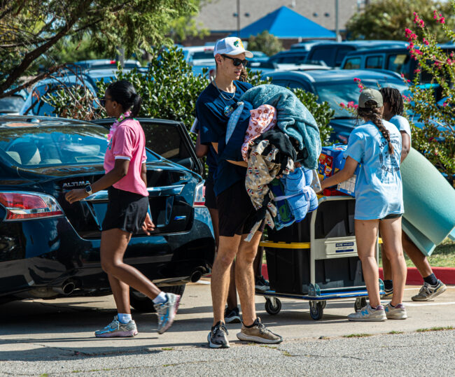 Thomas Wolff is unloading bedding for a UCO student. (Drew Rayburn/ The Vista)
