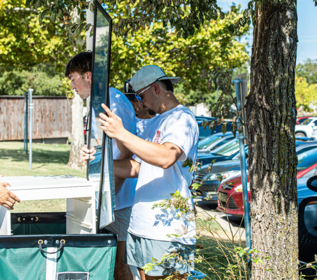 Micah McVay is moving a mirror into the Suites. (Drew Rayburn/ The Vista)