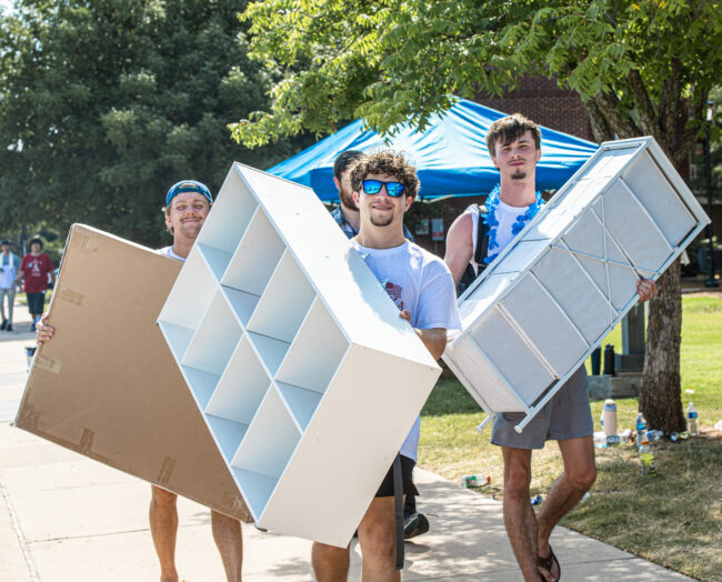 Pike volunteers are moving shelves for UCO students. (Drew Rayburn/ The Vista)