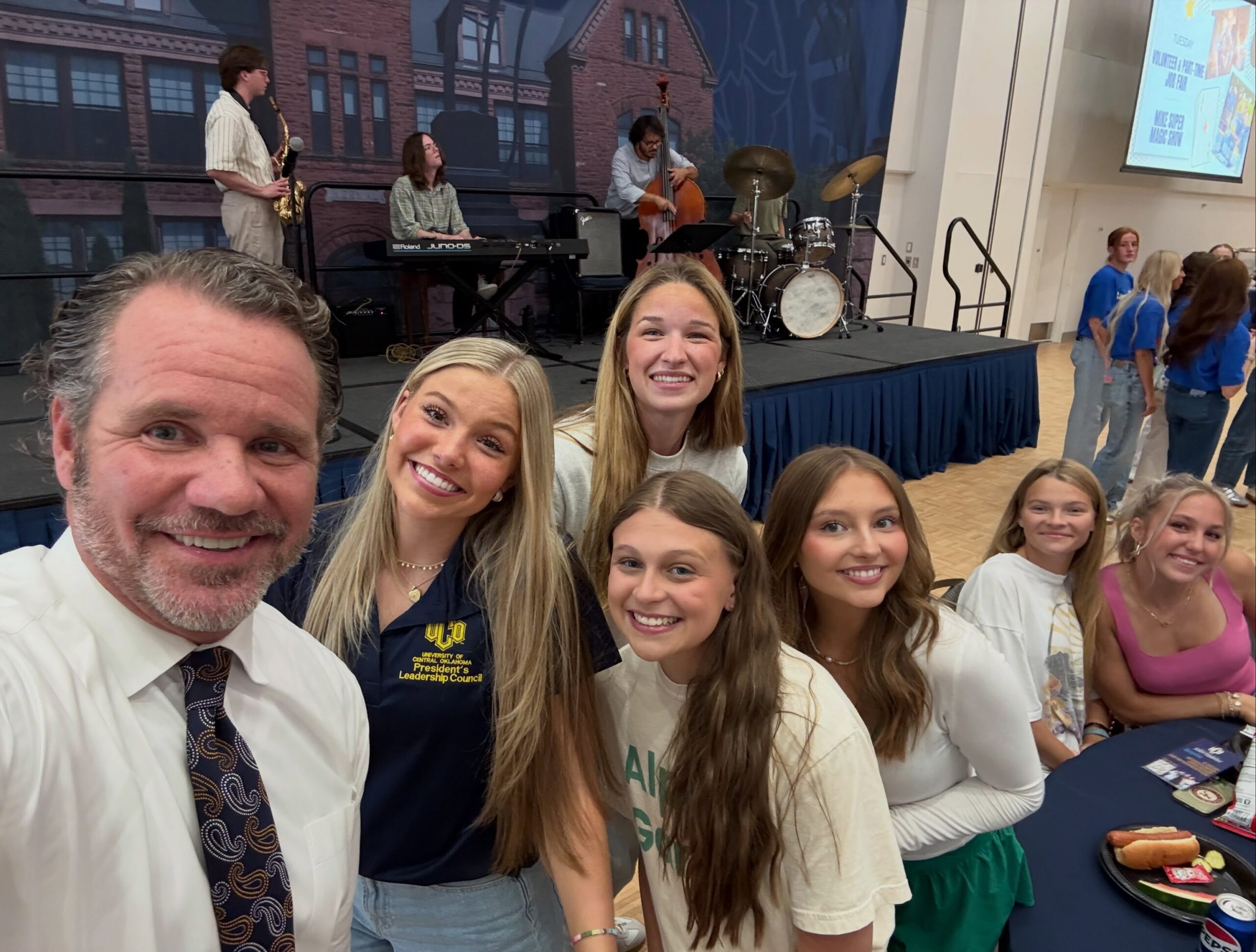 UCO President Todd Lamb takes a selfie with Leadership Council members and the incoming Freshman class in front of a live band.