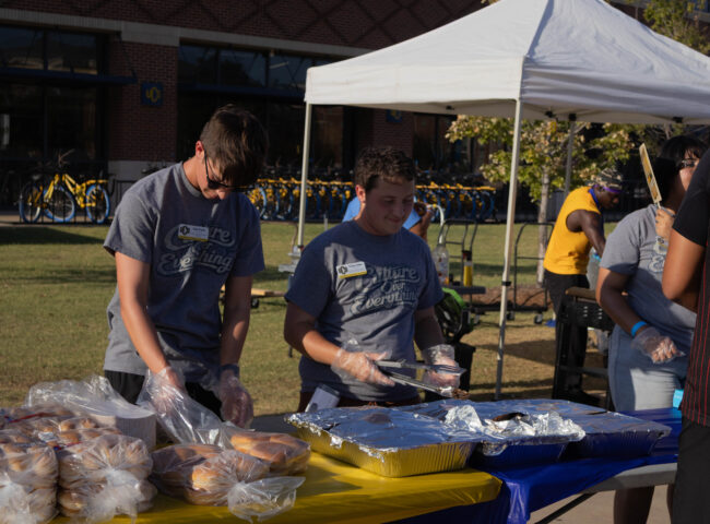 Two students serving food. (Maycee Elerick/The Vista)