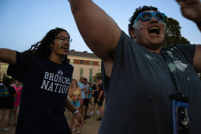 Two students dancing and cheering during Broncho's Night Out celebration. (Maycee Elerick/The Vista)