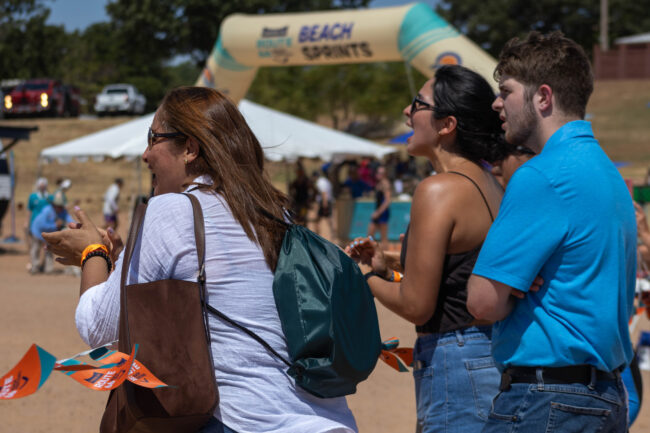Spectators cheering on the sideline. (Maycee Elerick/The Vista)