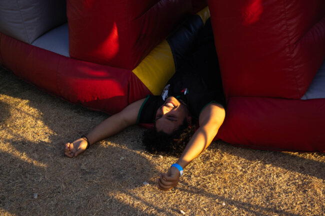 Student falling out of bounce house. (Maycee Elerick/The Vista)