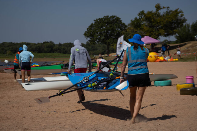 Volunteers move boats into place. (Maycee Elerick/The Vista)