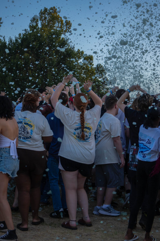 Students dance while green foam is spraying onto the crowd. (Maycee Elerick/The Vista)