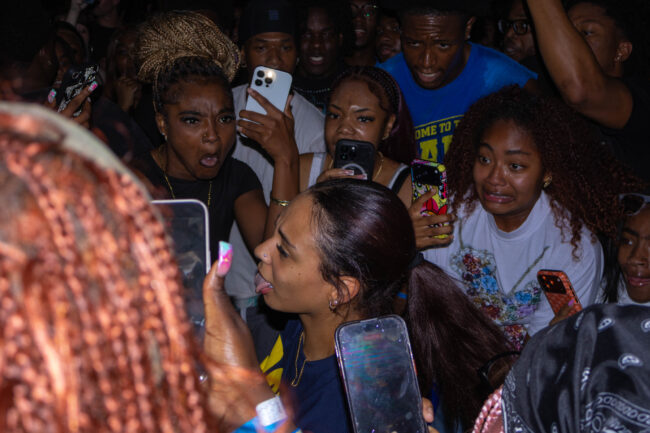 Students taking photos in a crowd. (Maycee Elerick/The Vista)
