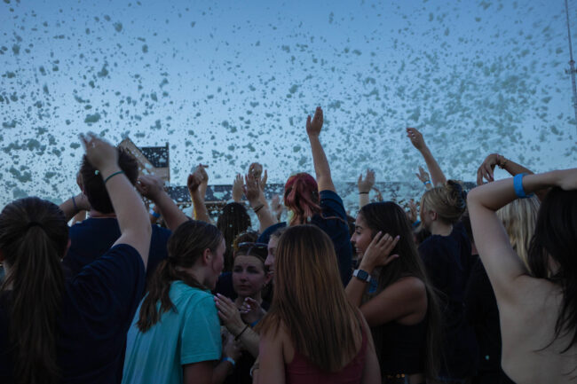 A crowd of students throwing their hands in the air and dancing to music. (Maycee Elerick/The Vista)
