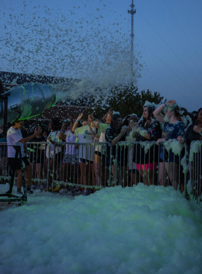 Students standing against barricades surrounded by piles of party foam. (Maycee Elerick/The Vista)