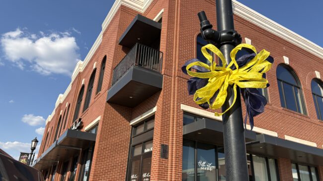 Madeline's Flowers and Greenhouse put up decorative ribbons on street poles lining broadways streets in Edmond 