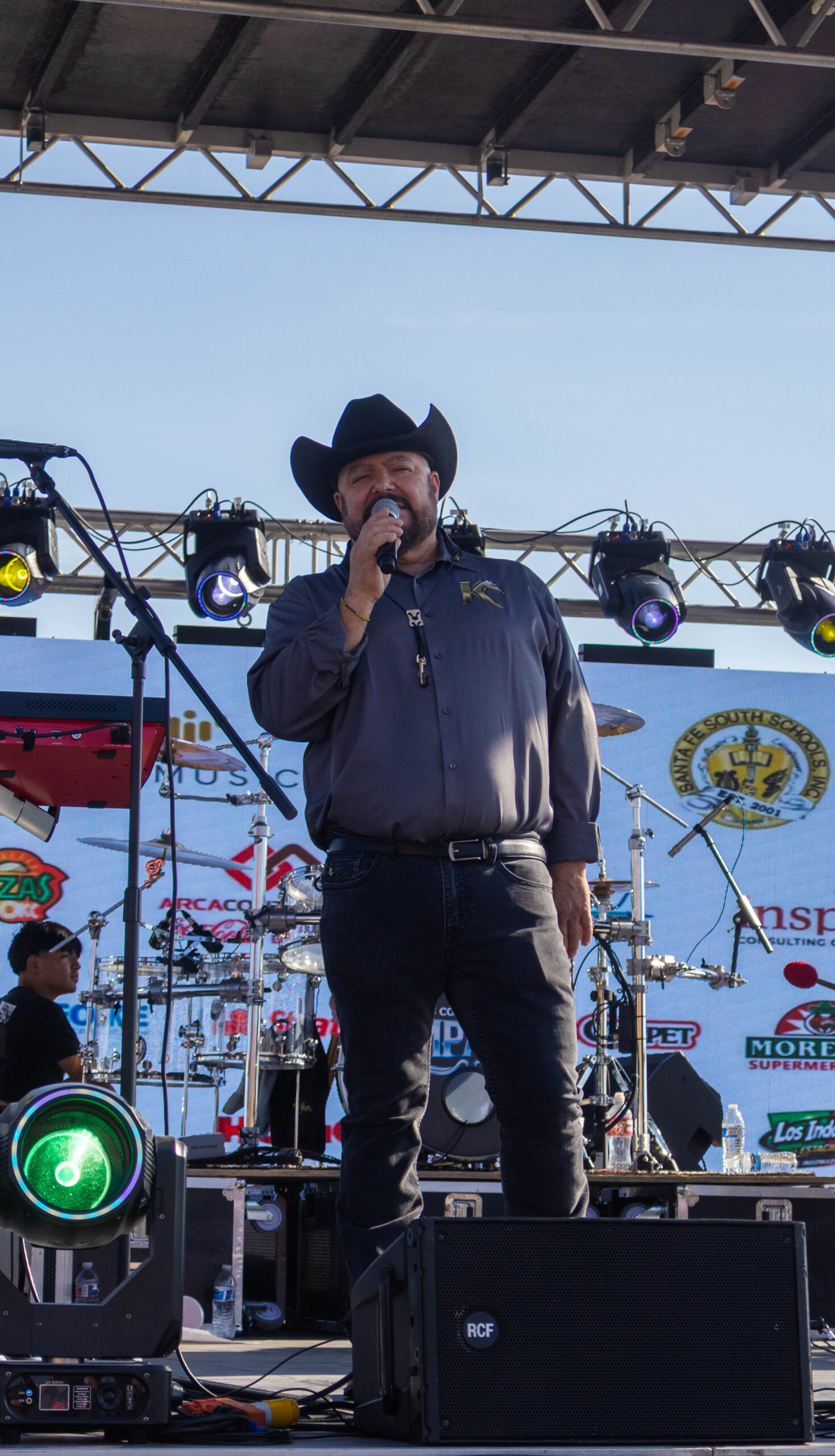 A band member sings on stage. (Maycee Elerick/The Vista)