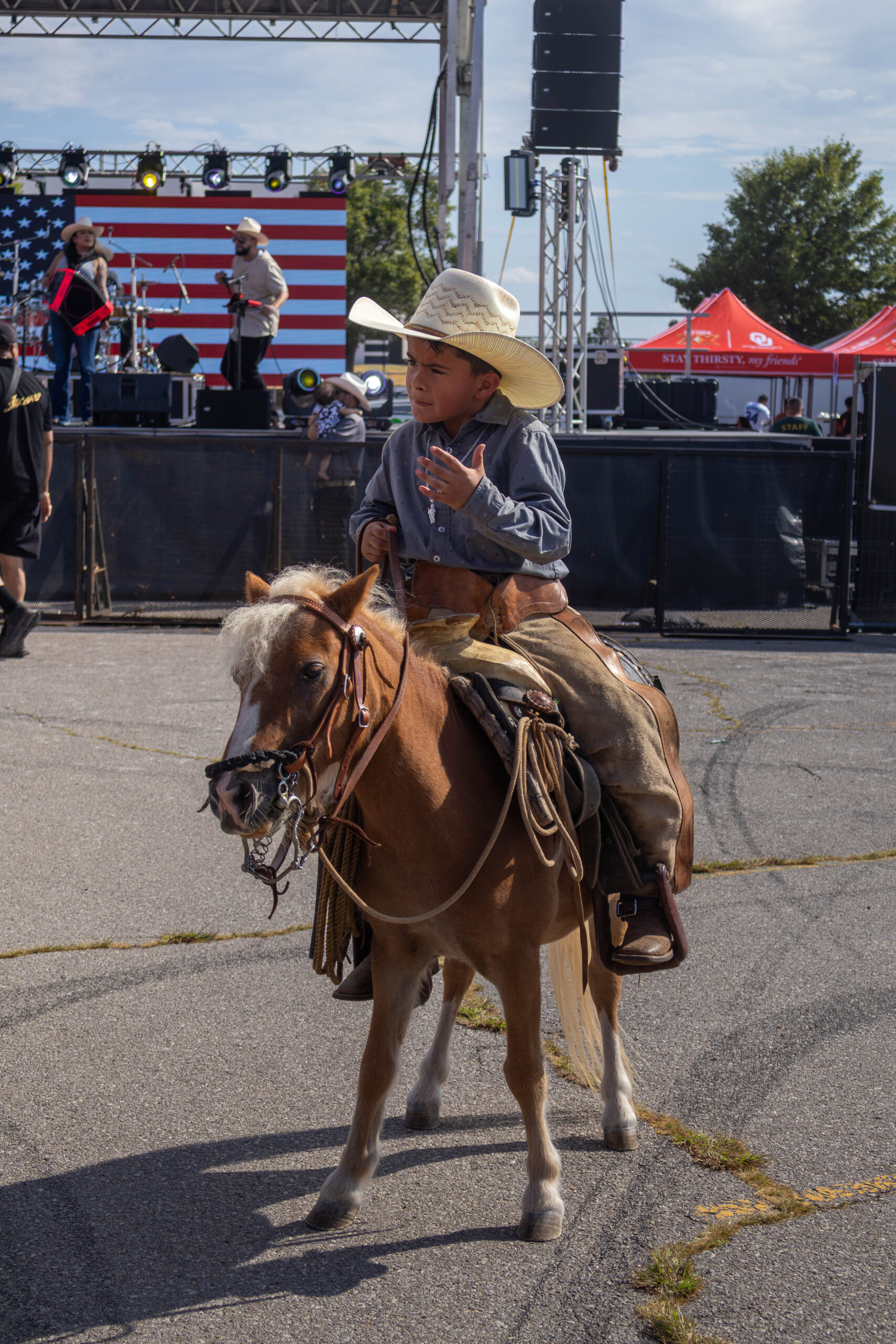 Child rides smaller horse and speaks to spectators. (Maycee Elerick/The Vista)
