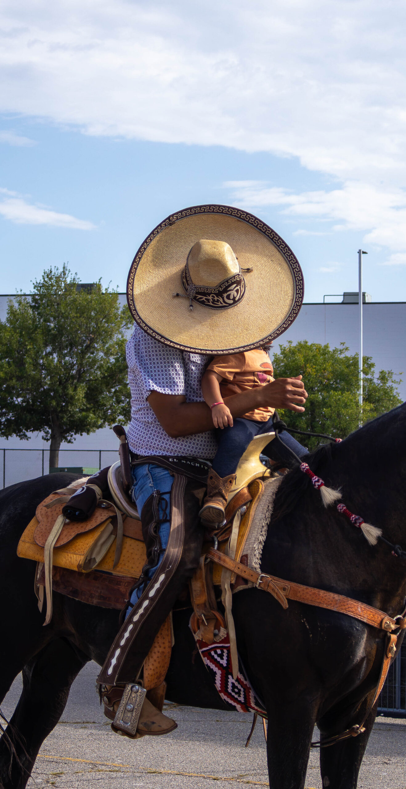 Man riding with his daughter on horseback. (Maycee Elerick/The Vista)