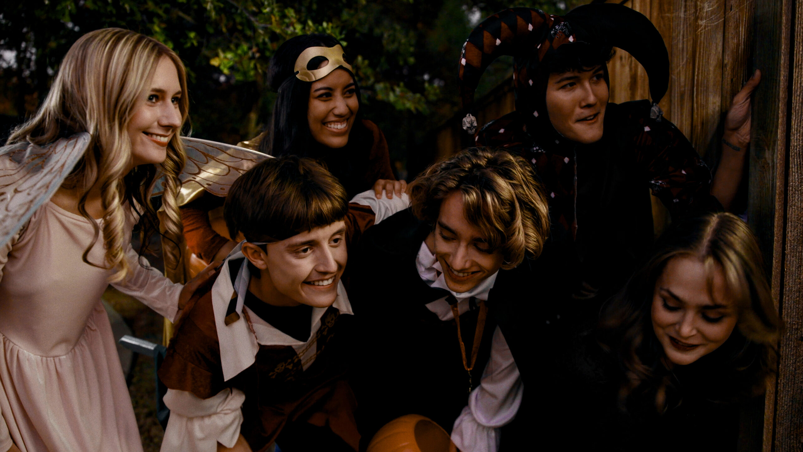 A group of people dressed in halloween costumes: pirates, fairy's, jesters, etc. from the film Hansel and Gretel's Halloween. 
