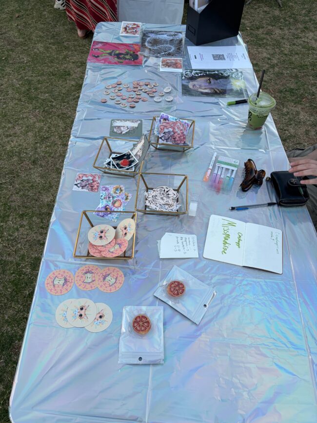 A table with a holographic cover shows many stickers with various designs.