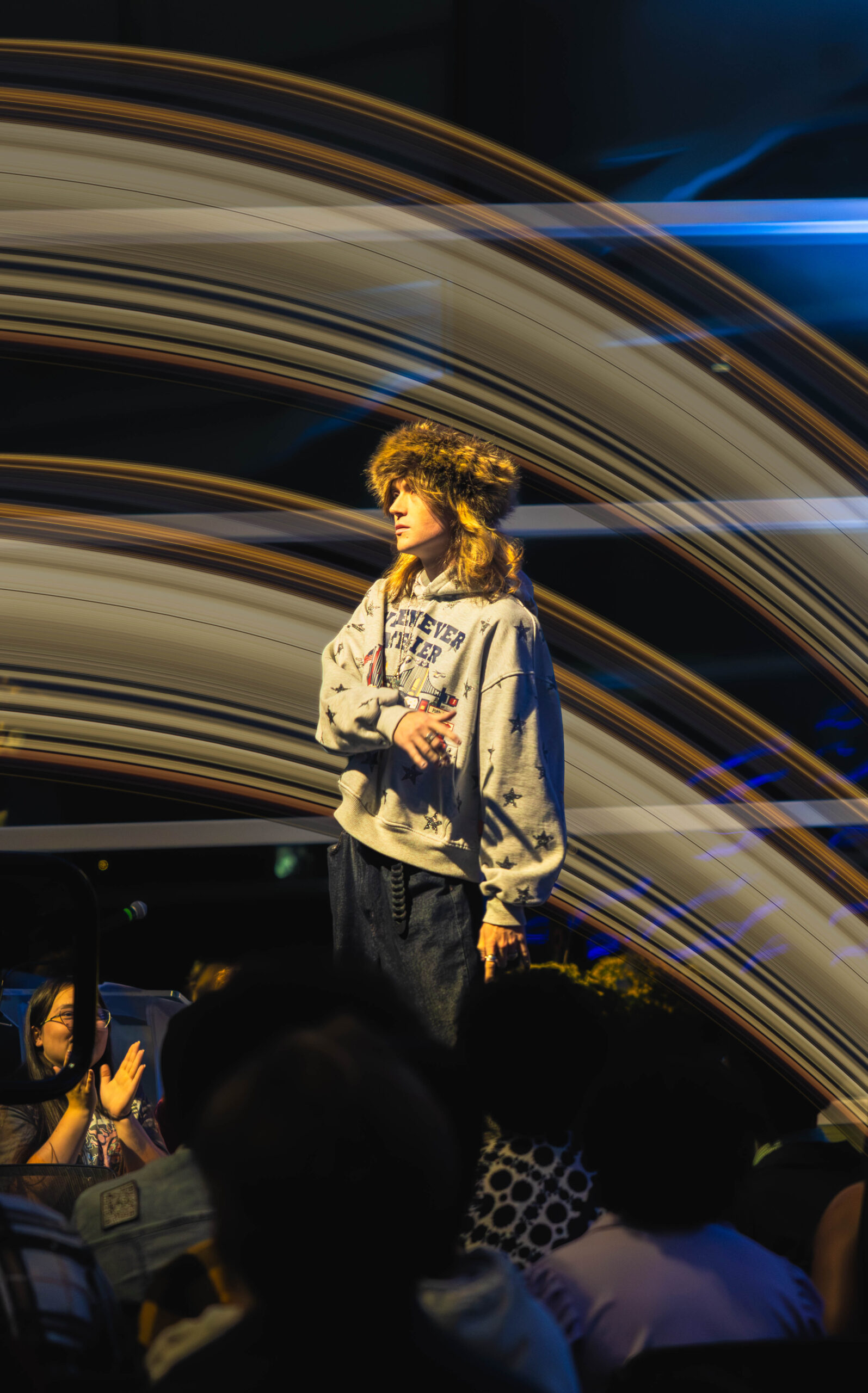 Model reaches to his side on stage. (Maycee Elerick/The Vista)