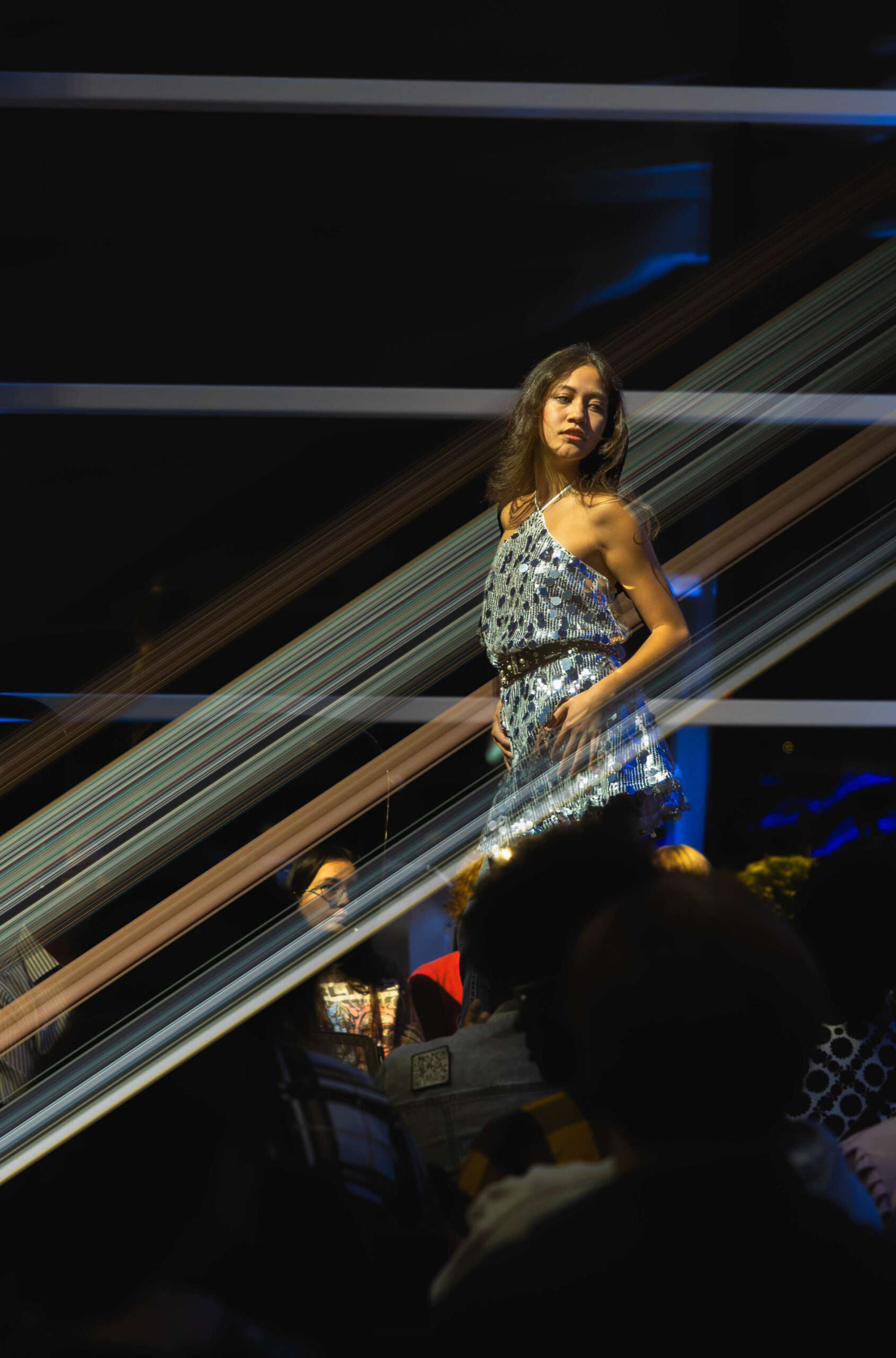 Model poses in a shiny dress (Maycee Elerick/The Vista)