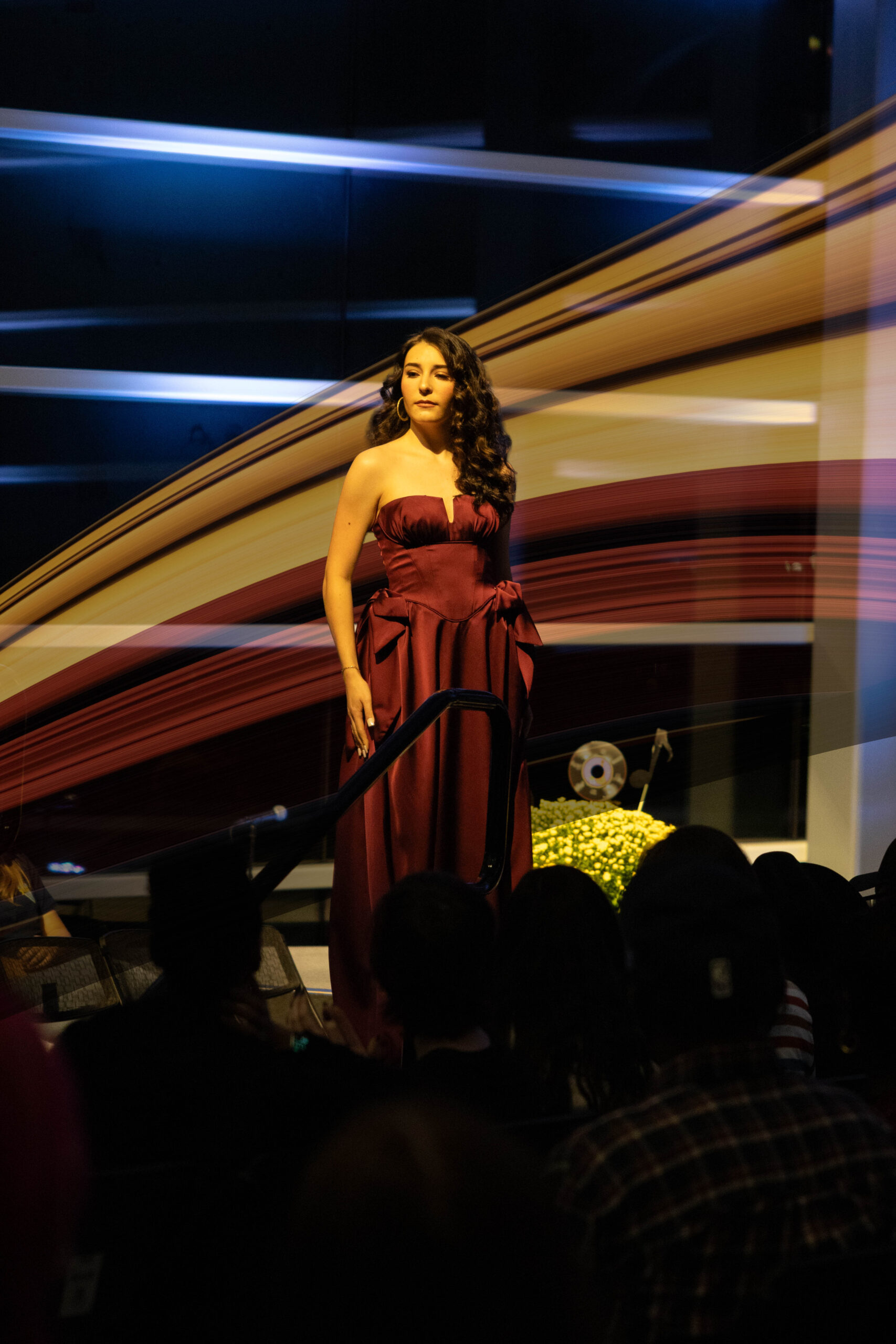 A model poses in a red dress (Maycee Elerick/The Vista)