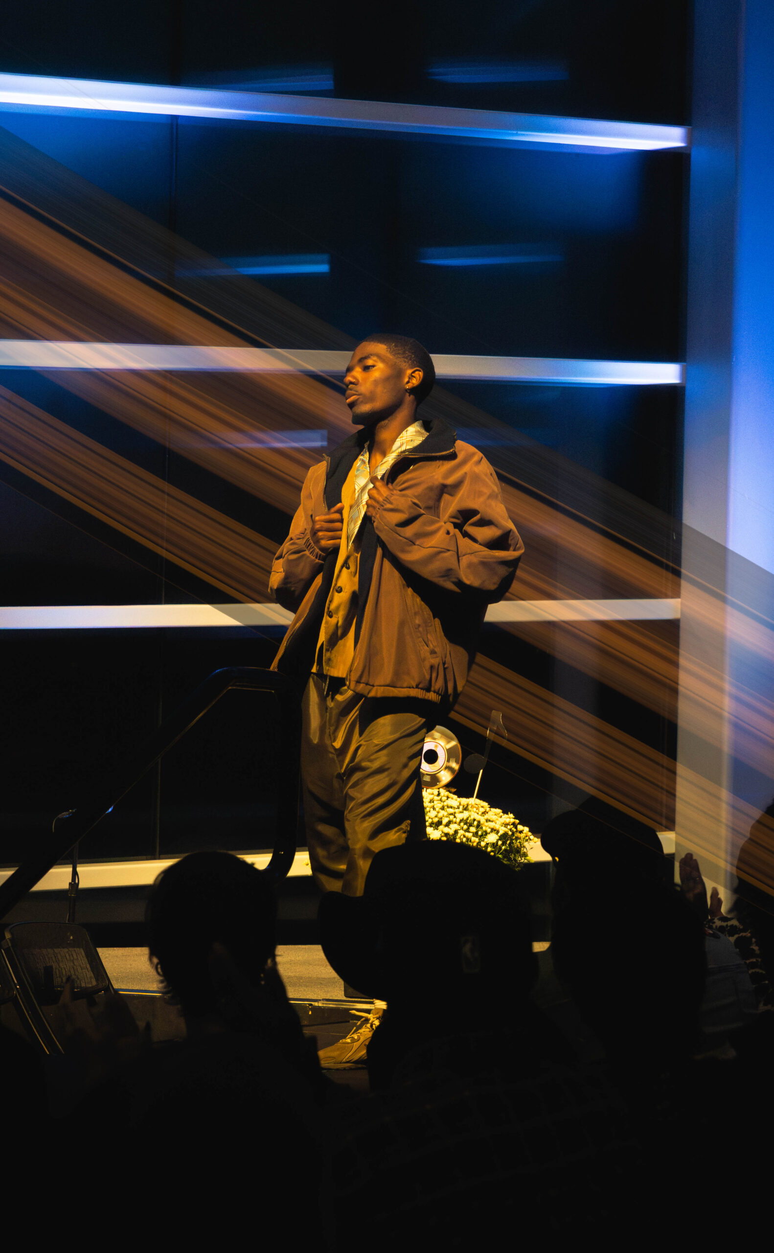 Model on stage grabbing his jacket (Maycee Elerick/The Vista)